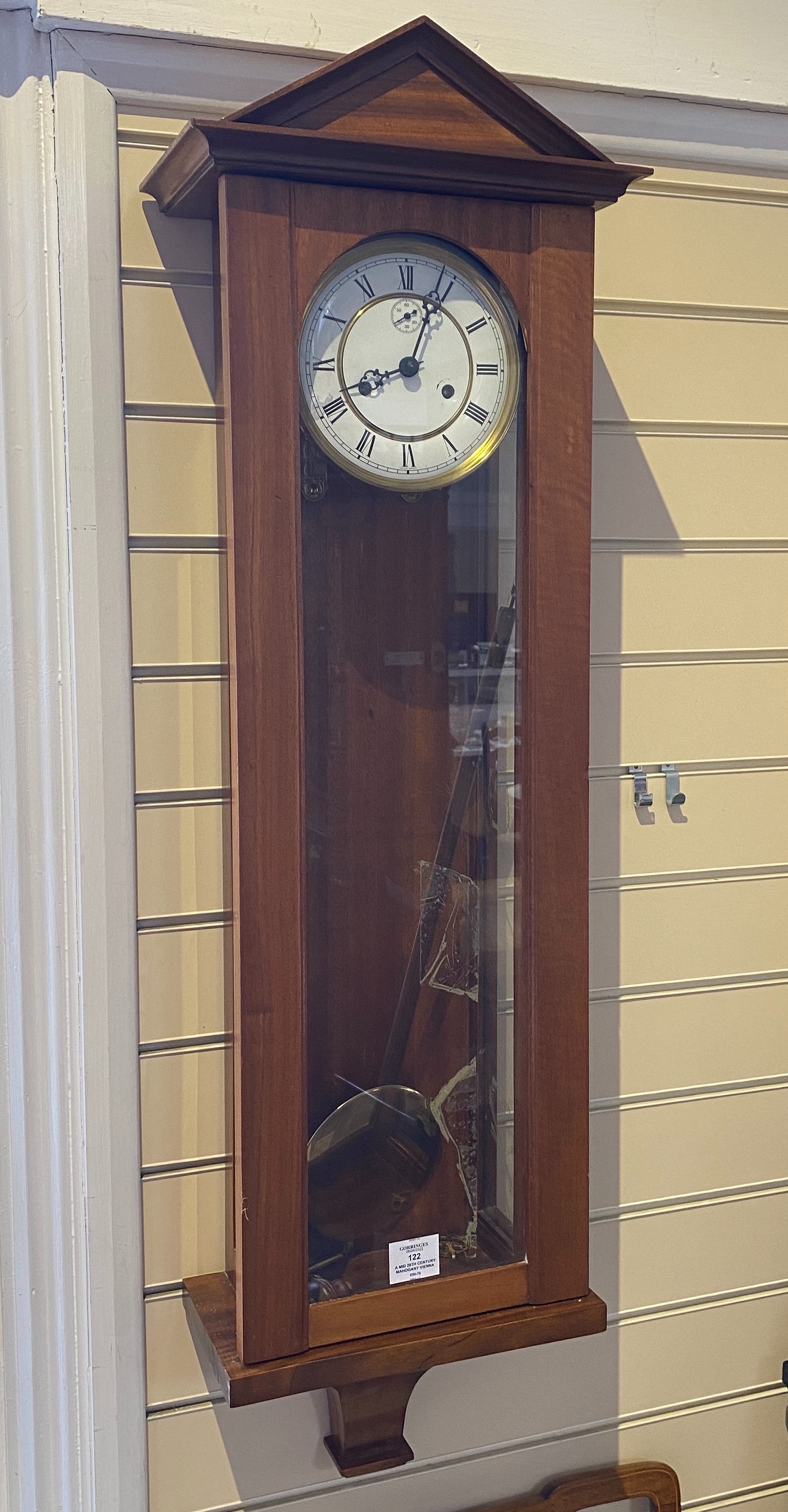 A mid 20th century mahogany Vienna type 8 day wall clock the circular white enamel dial with subsidiary seconds, height 112 cms.